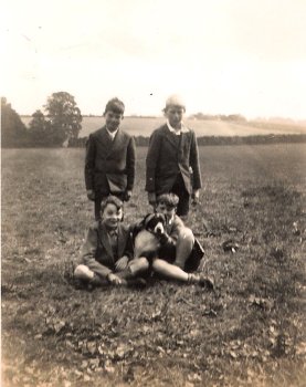 Dennis Bowden sitting crossed legged. Others unknown