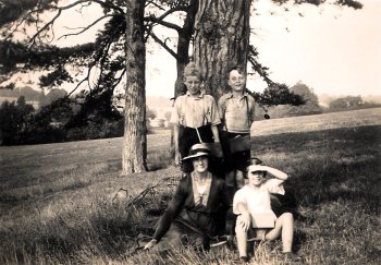 Dennis Bowden standing behind girl.  The woman with hat is his mother Alice Bowden nee Johnson.  Others Unknown.