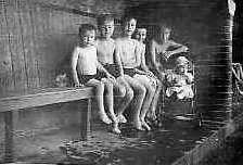 Colin, Arthur (Collins), John, Mark,
Brian (Collins) with Ann Weightman in
pushchair c.1949 in the paddling pool changing
shed. Photo: Colin Weightman See story Clean
Lake, Dirty Lake, Our Lake Districts and The
Boy & The Country Tramp